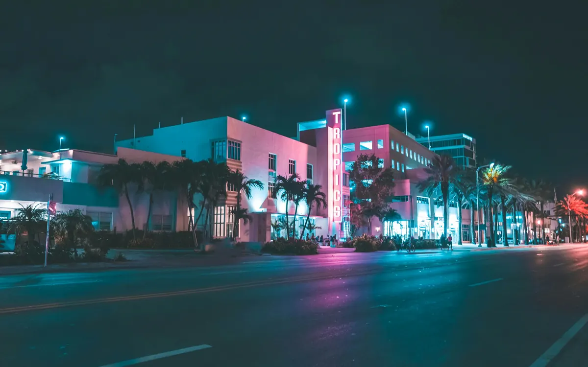 Ocean Drive in Miami Beach at night with neon-lit hotels